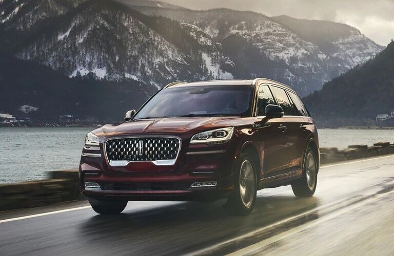 Front driver angle of a dark red 2021 Lincoln Aviator