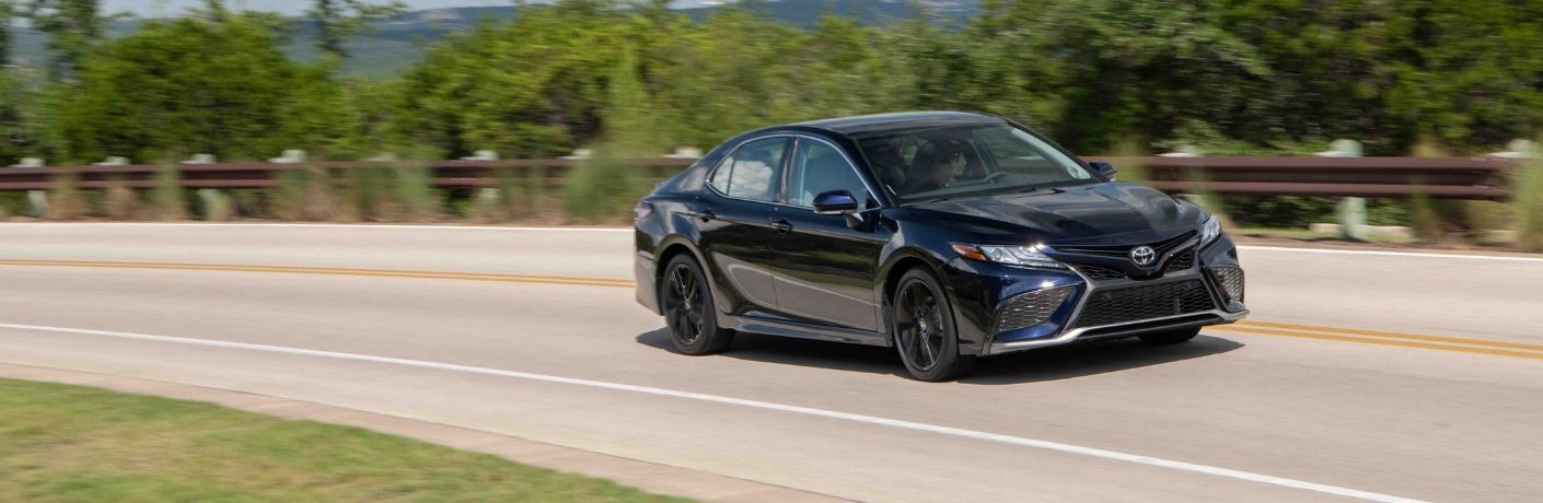Used Toyota Camry Blue driving on the road