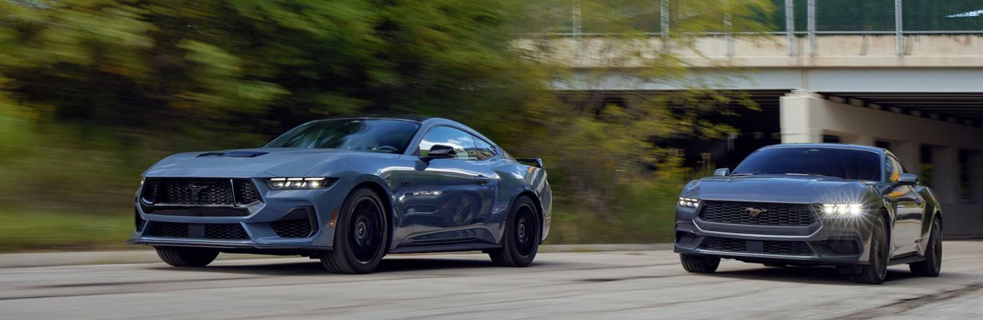 Two 2024 Ford Mustang EcoBoost® Fastback sports cars on the road