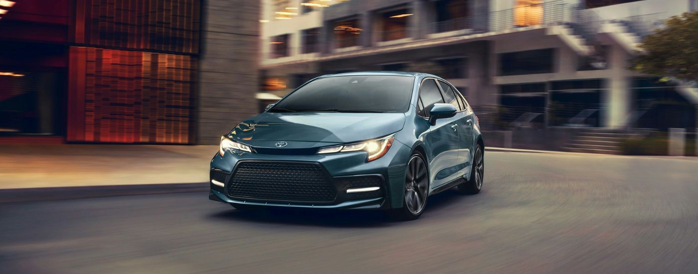 Blue 2020 Toyota Corolla driving on a city street