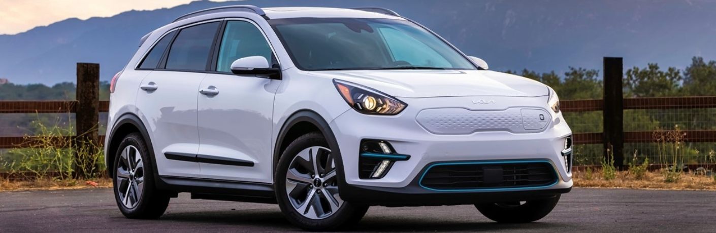 A 2022 Kia Niro EV backdropped by a hill