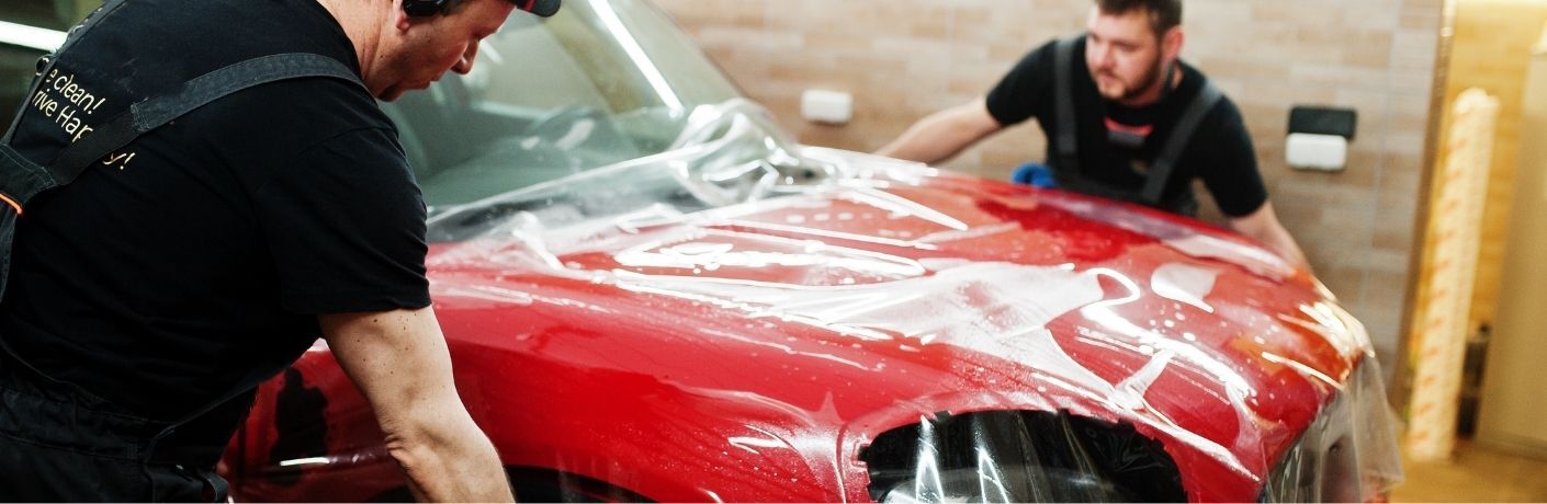 Two people working on a vehicle