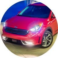 Circle image of the bi-function projection headlights on a red 2019 Kia Niro