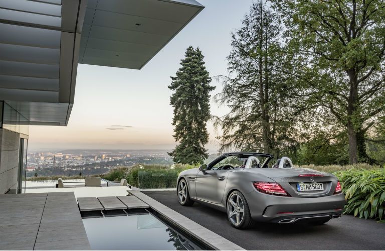 silver Mercedes-Benz convertible parked outside modern home