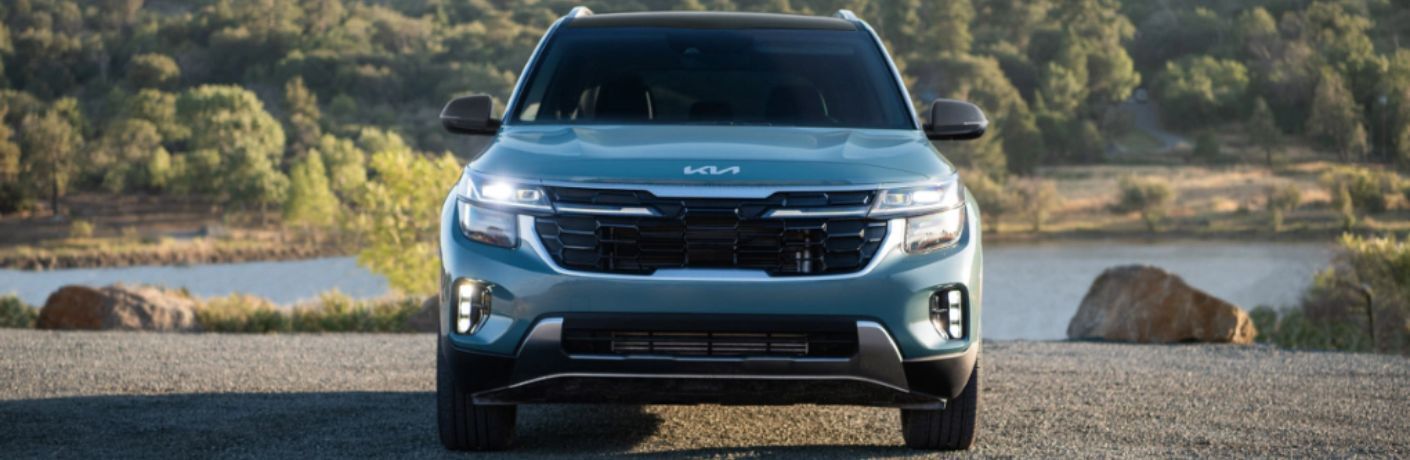 Front view of a 2024 Kia Seltos on a gravelly terrain