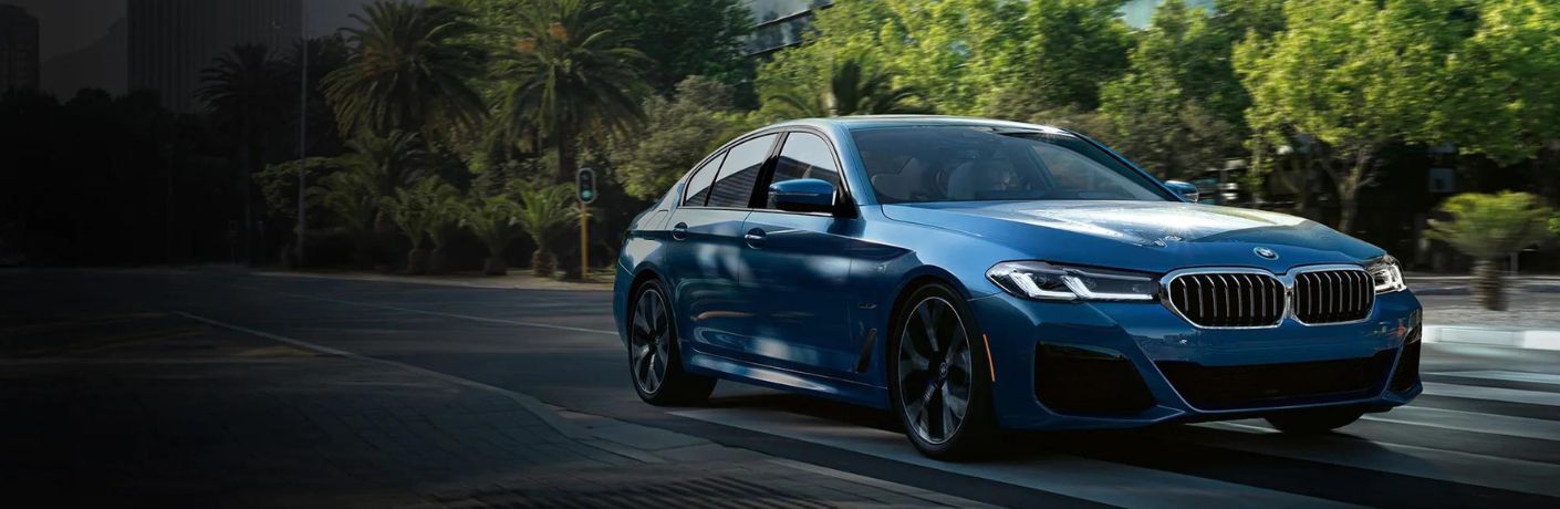 A blue color BMW on the road