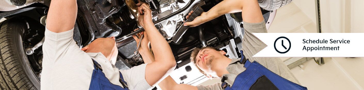 two men working under car with schedule service icon