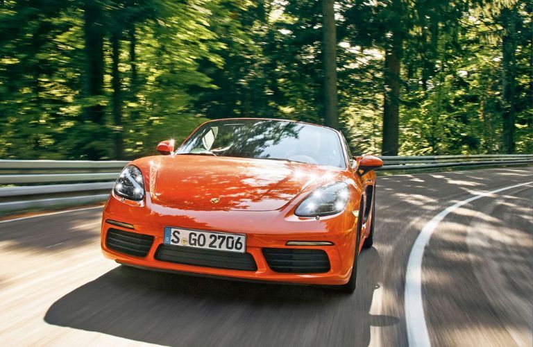 A 2016 Porsche Boxster speeding on a road