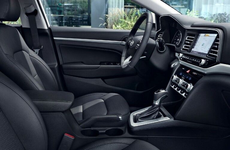 Showing front row black leathered seats with interior dashboard of used Hyundai Elantra