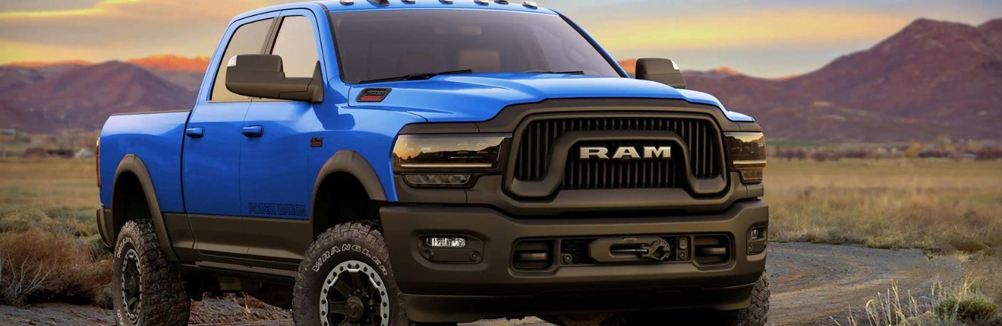 One blue color 2022 Ram 2500 is parked on the road.