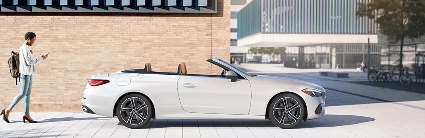 2024 Mercedes-Benz CLE 300 4MATIC Cabriolet parked outside a building and a woman walking