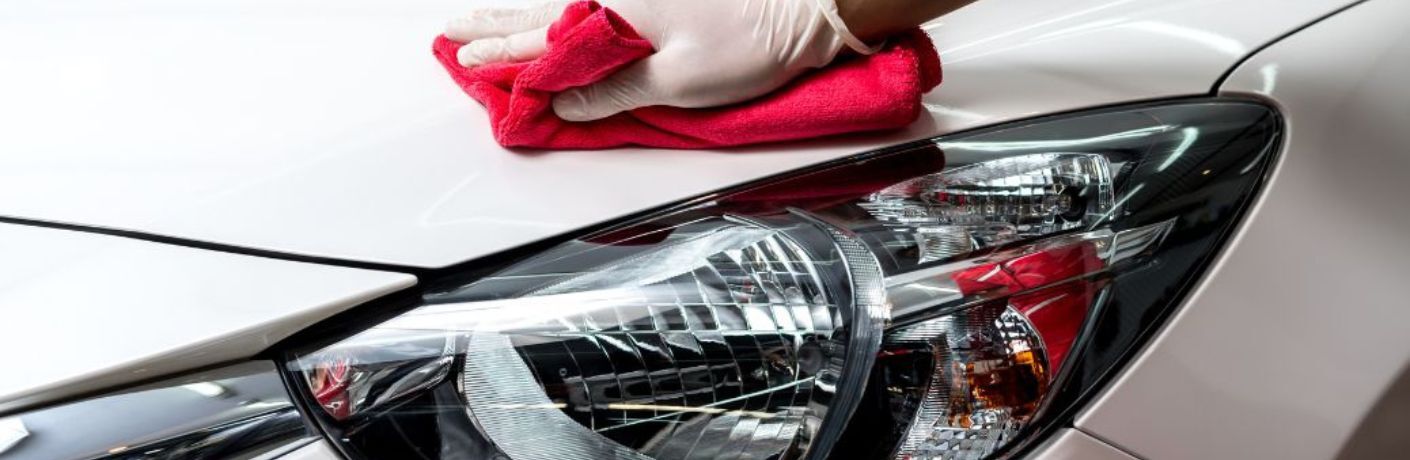 Hand of a man wiping a car