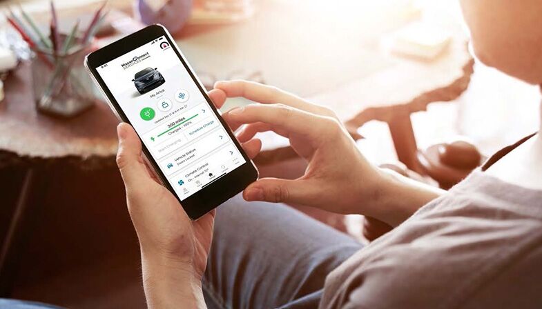 Person on their phone viewing NissanConnect