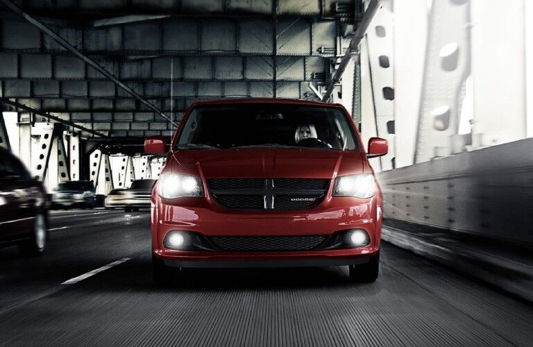 Front angle of a red 2019 Dodge Grand Caravan driving on a road