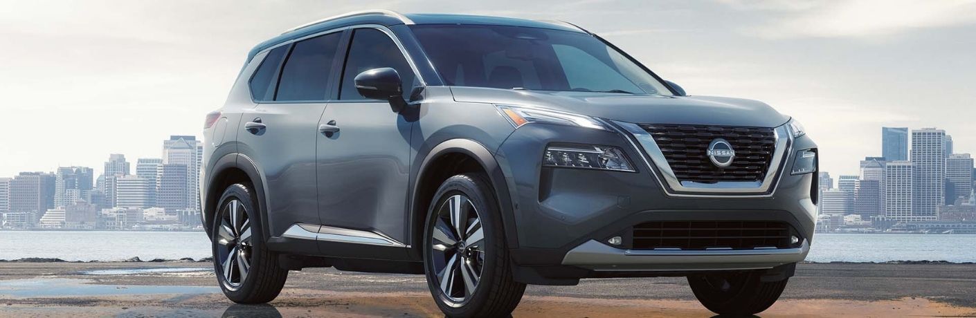 Used Nissan Rogue Gray parked near lake
