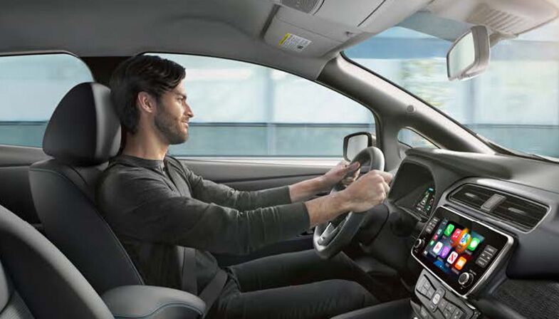 Interior shot of man driving a Nissan EV