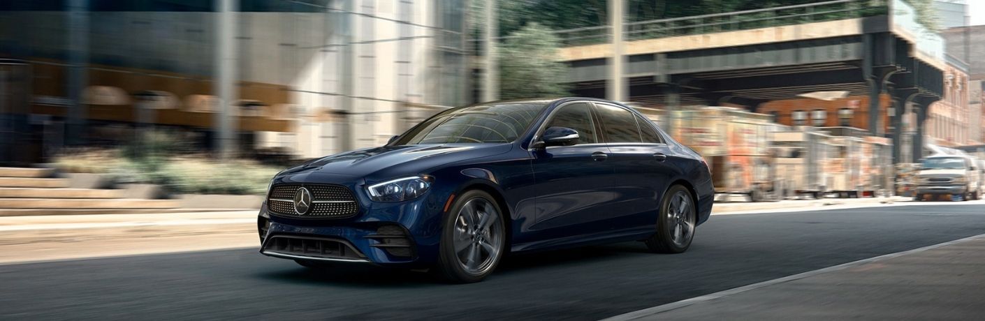 A blue Mercedes-Benz E 350 driving on a road