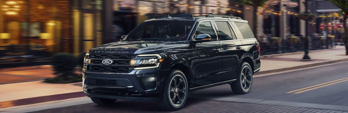 A 2023 Ford Expedition speeding on a city road