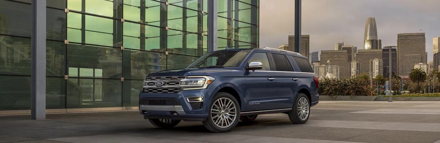 One blue color 2022 Ford Expedition is parked outside a building.