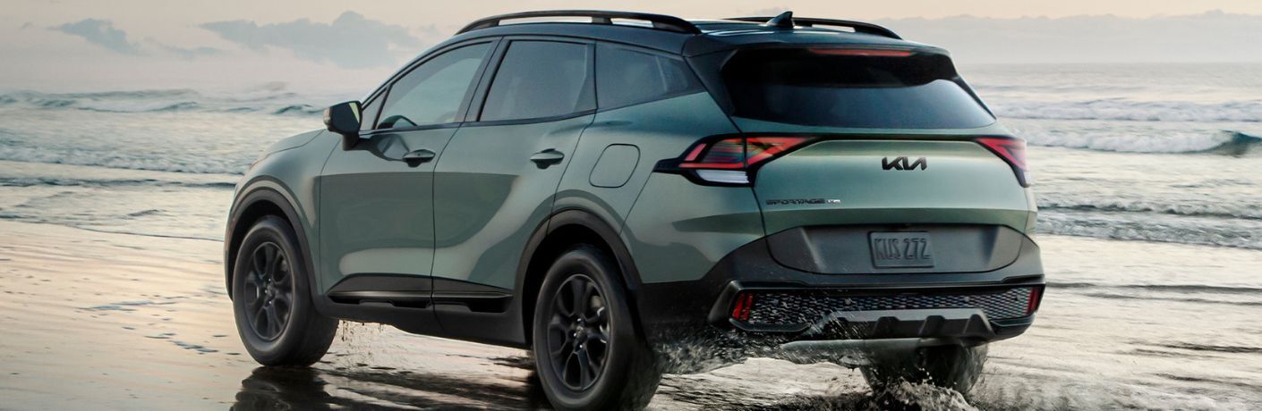 diagonal rear-view image of the 2025 Kia Sportage in a beach