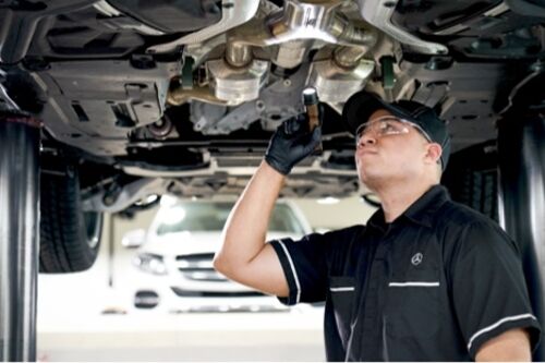 MB technician servicing car underbody