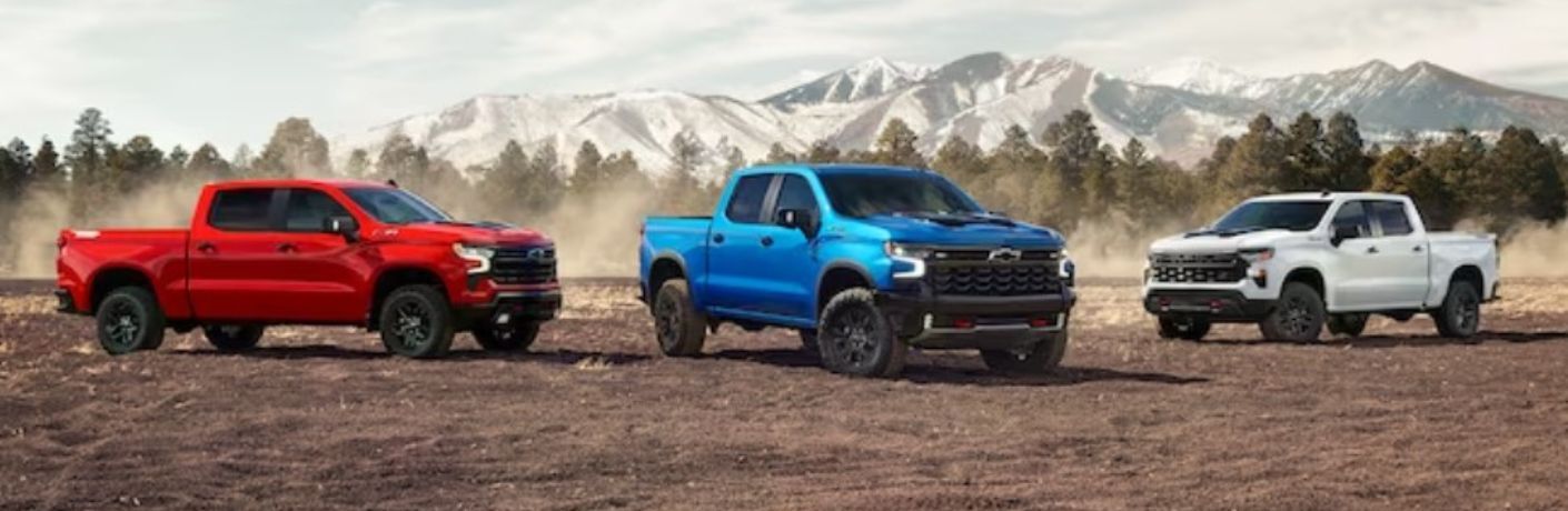 three Chevrolet trucks parked outside