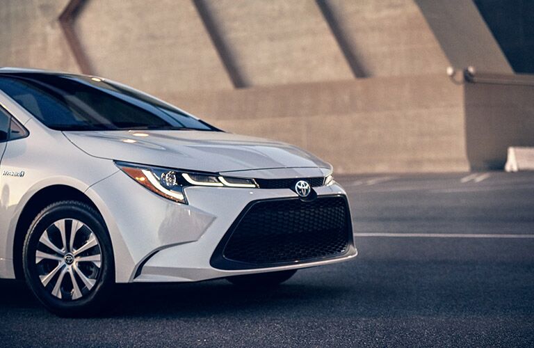 Grille, headlights, and wheel on white 2021 Toyota Corolla Hybrid