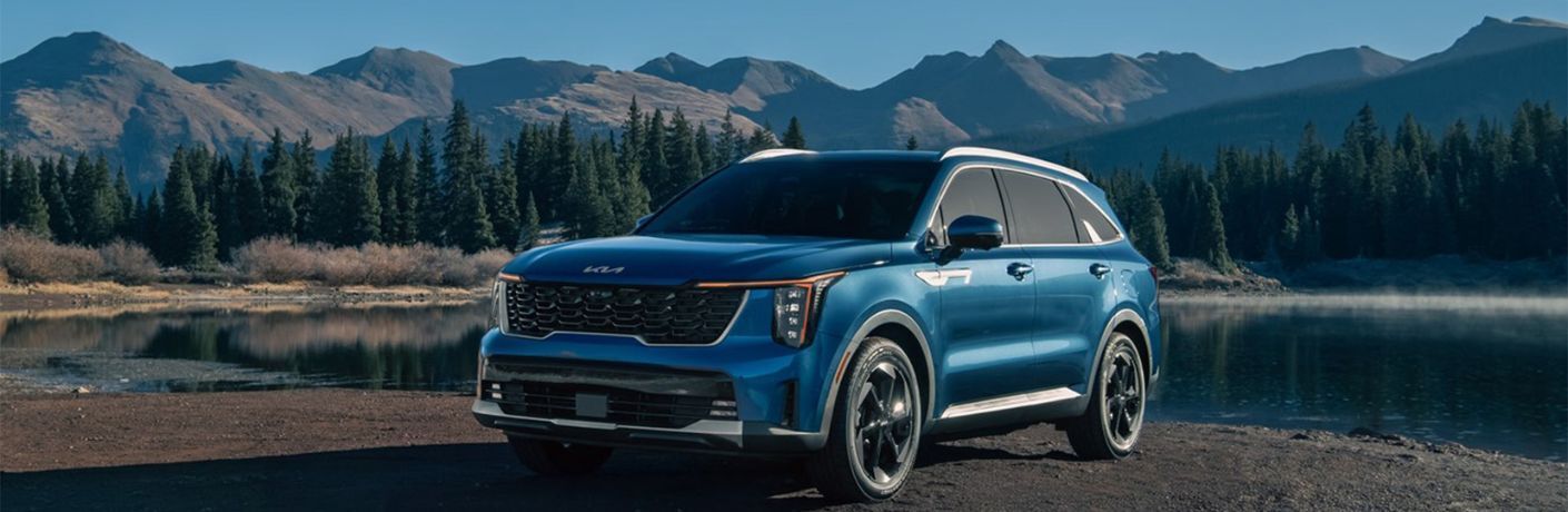 2025 Kia Sorento Hybrid parked off-road near a lake