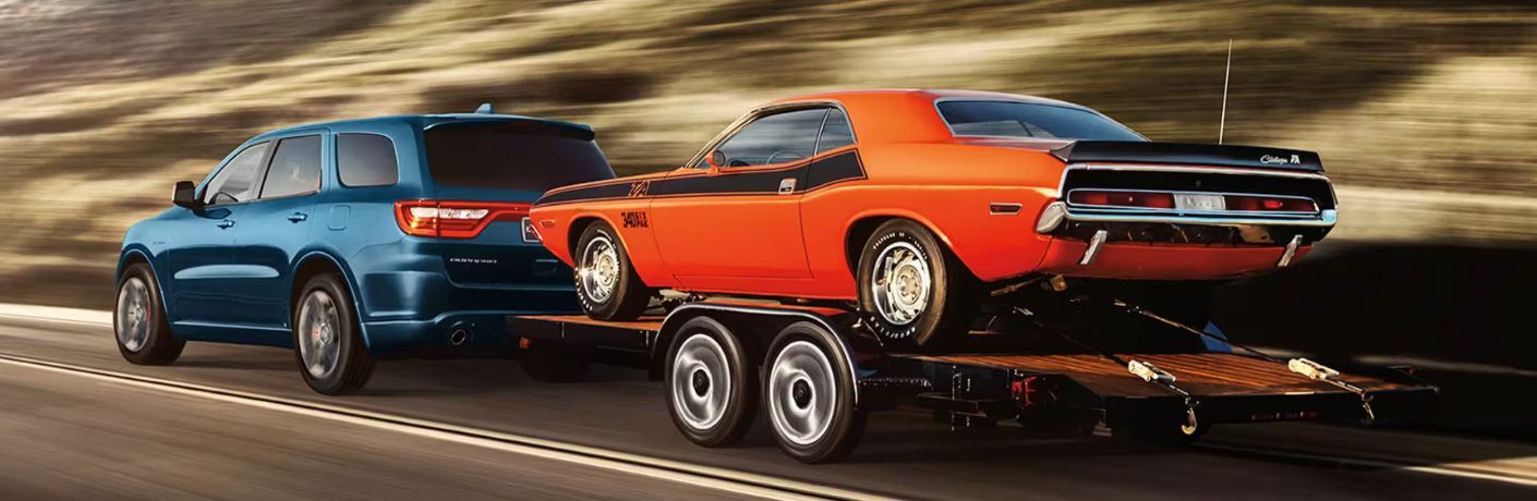 rear quarter view of the 2024 Dodge Durango towing a car