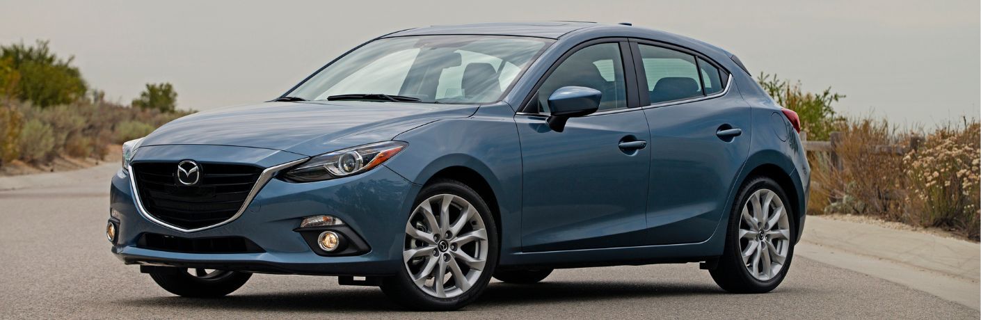 Sideview of the 2014 Mazda3 parked on the road