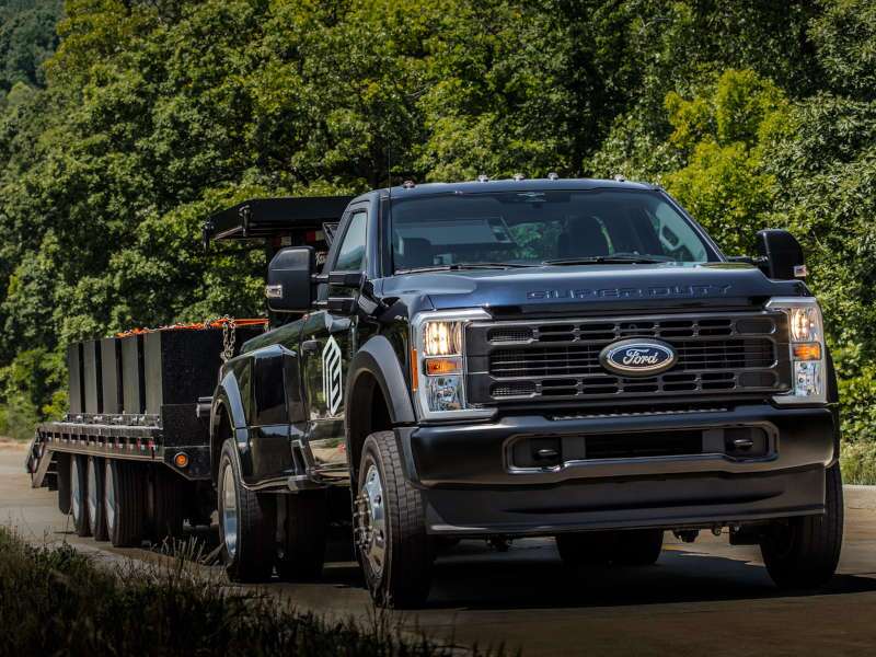 A Ford dual-wheel pickup truck towing a large trailer