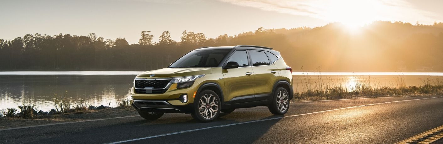 2021 Kia Seltos on a highway near water at sunset