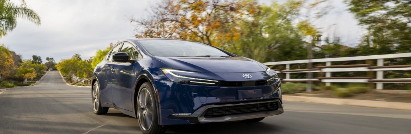 An image of the side view of a blue colored 2023 Toyota Prius