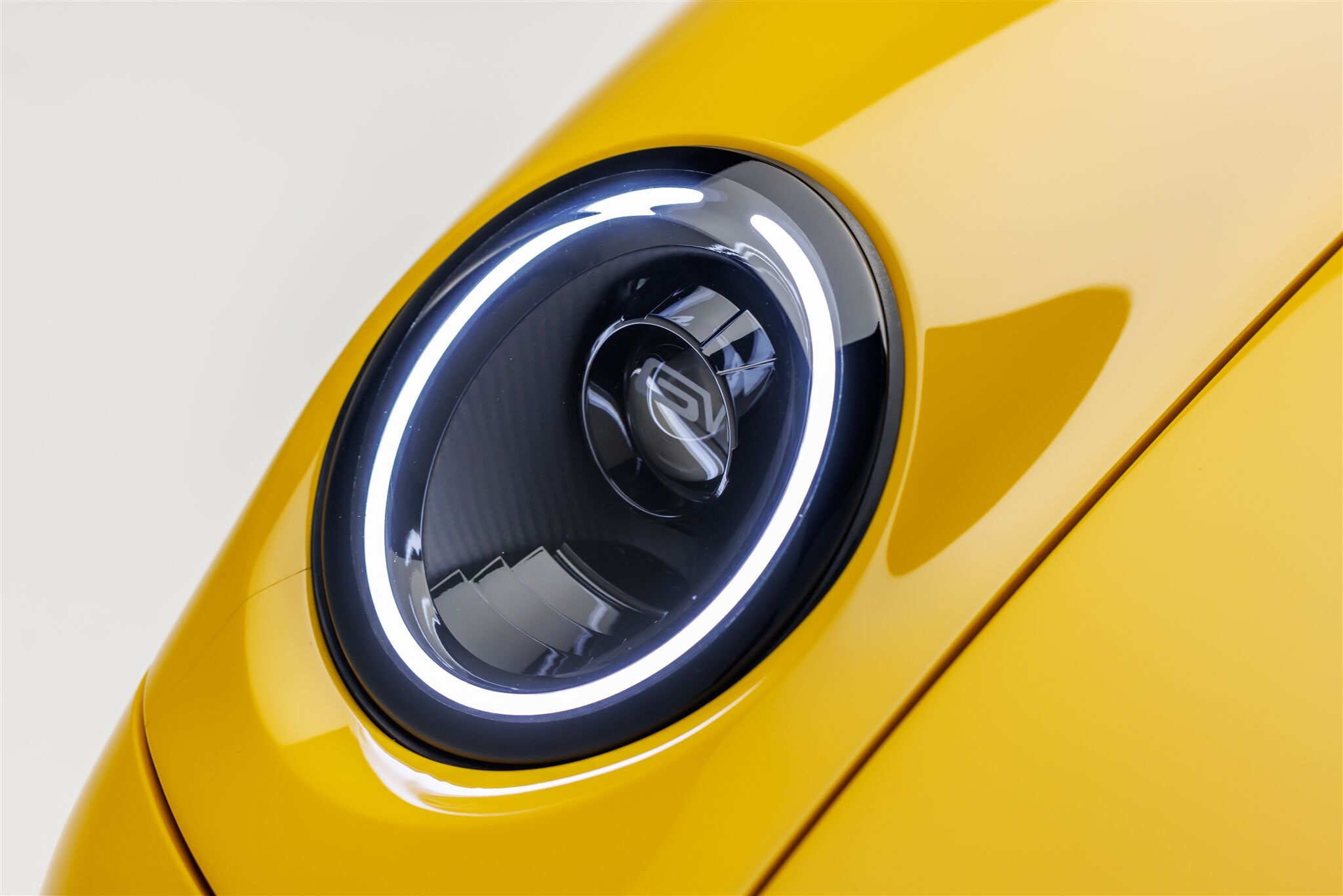 yellow Porsche Coupe model round headlight close up