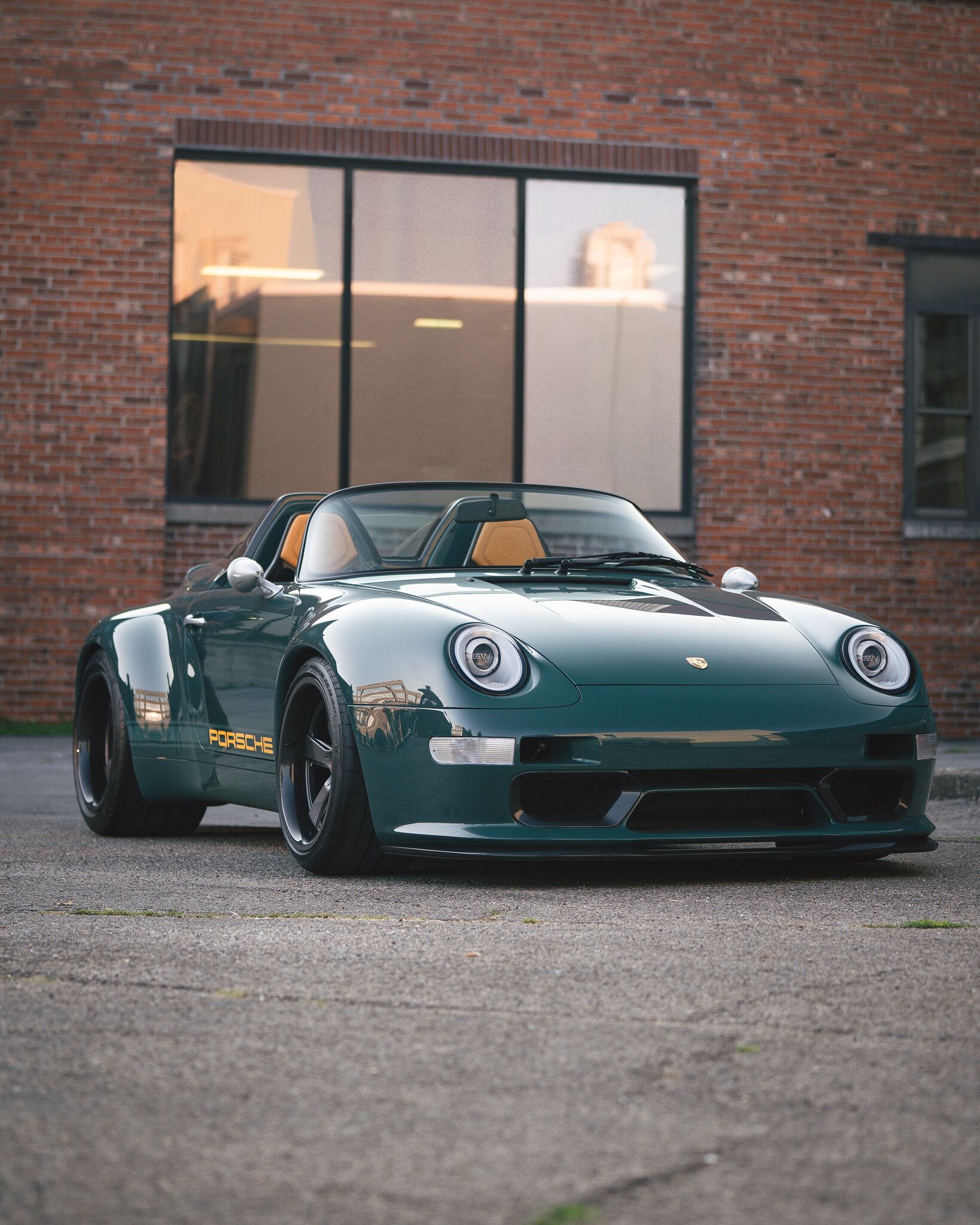 Porsche Speedster model front view in front of a brick building