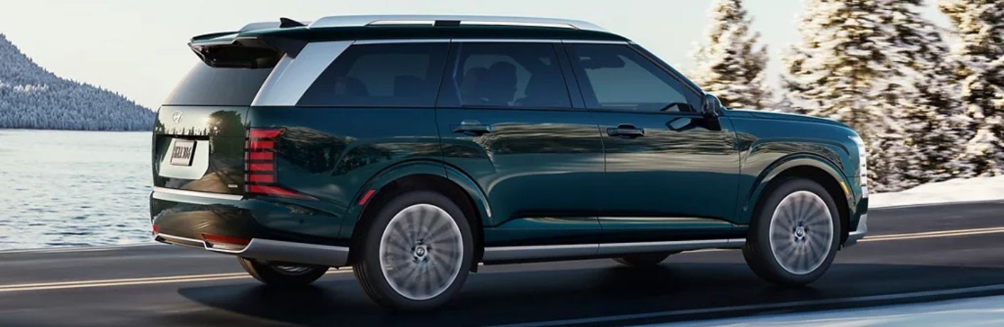 2026 Hyundai Palisade Calligraphy side and rear view on a road