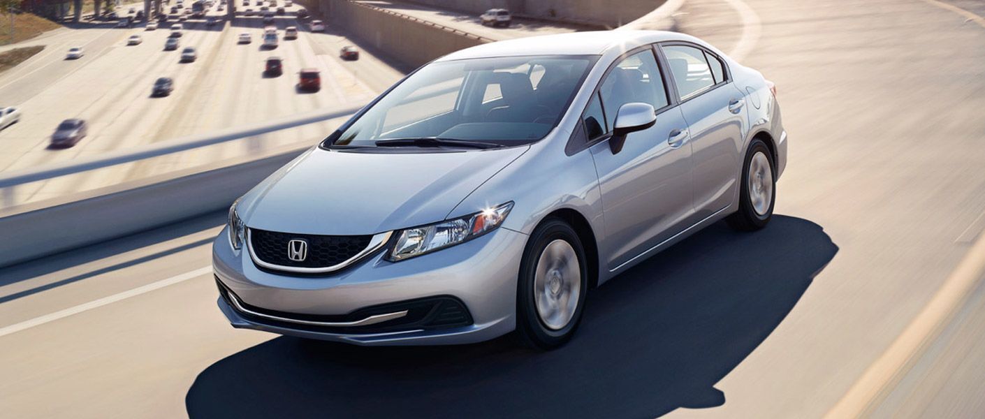 Used Honda Civic Gray driving on the road