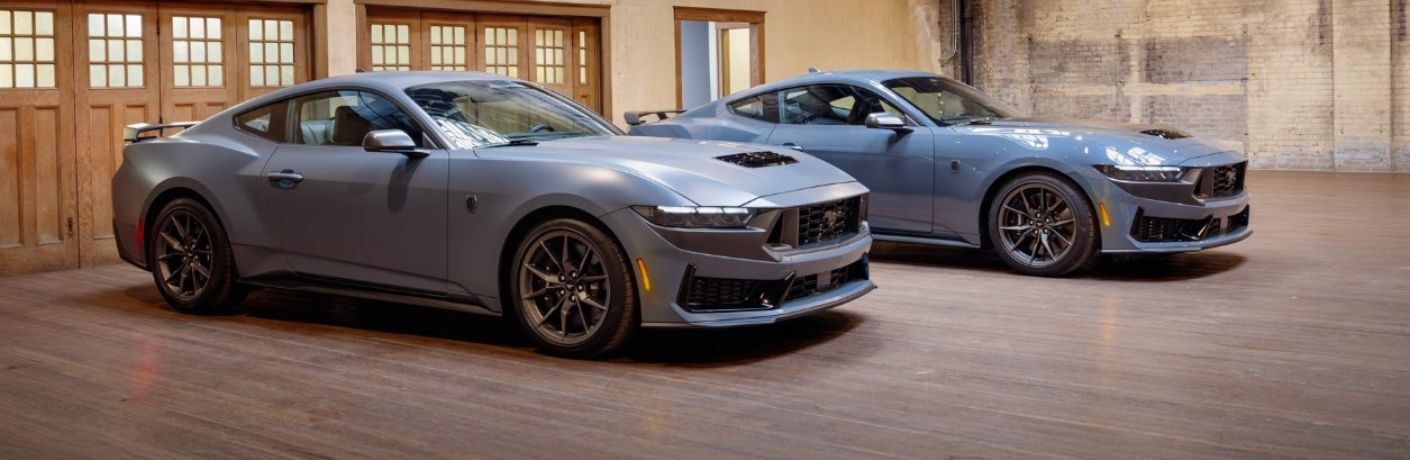 two 2026 Ford Mustang models in a garage