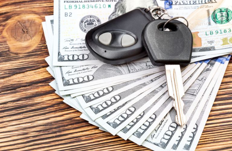 Car key placed on dollar bills