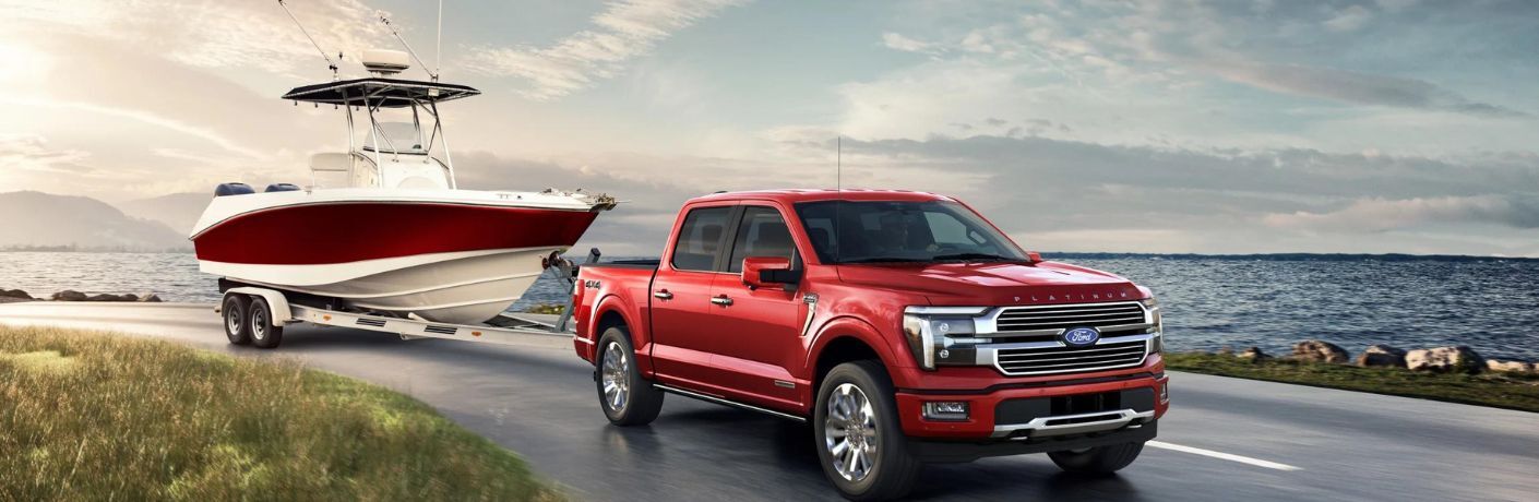 2024 Ford F-150 Red towing a white boat