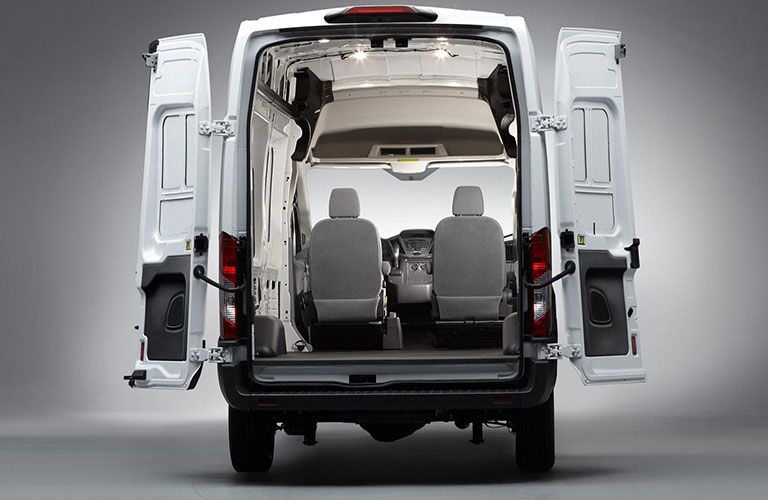 rear view of white 2018 ford transit cargo van with cargo doors open showing inside