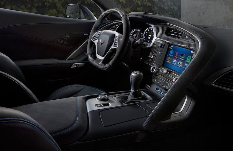 side view of front interior of 2019 chevrolet corvette including steering wheel and infotainment system