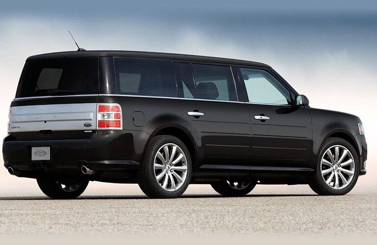 rear view of black 2019 ford flex against white and blue background