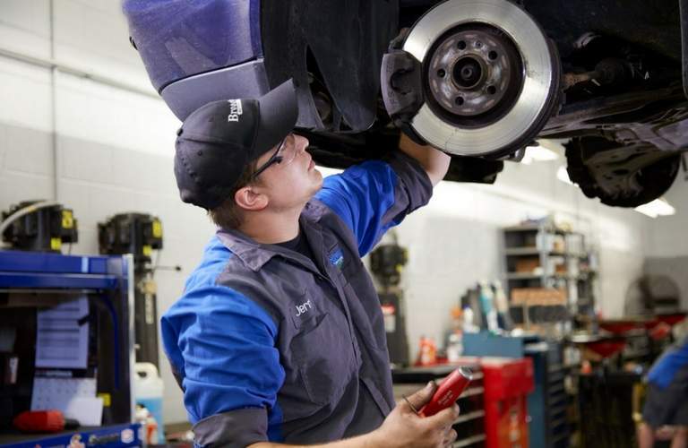 Broadway Automotive employee working on car brakes
