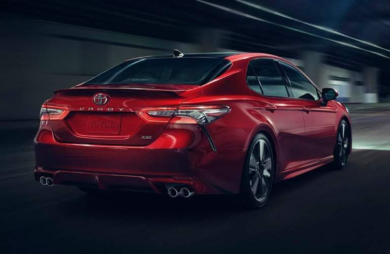 rear view of a red 2018 Toyota Camry in a tunnel