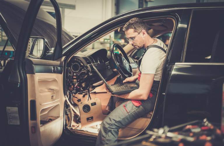 Technician Using Diagnostic Computer to Fix Car