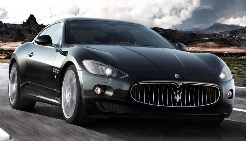 full view of the 2018 maserati granturismo driving in a valley