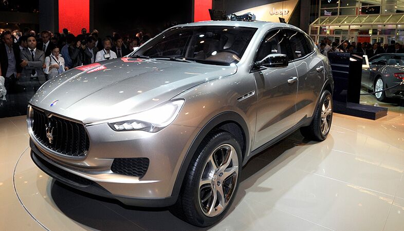 full view of the 2018 maserati levante at an auto show with a crowd looking at it