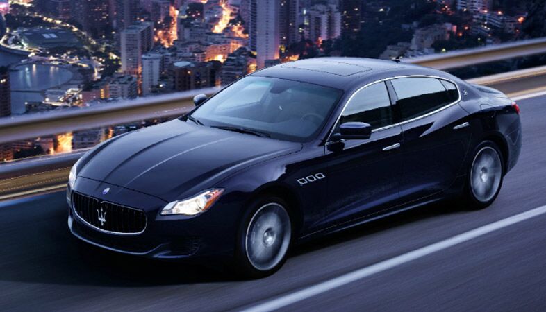full view of the 2018 maserati quattroporte driving in a city
