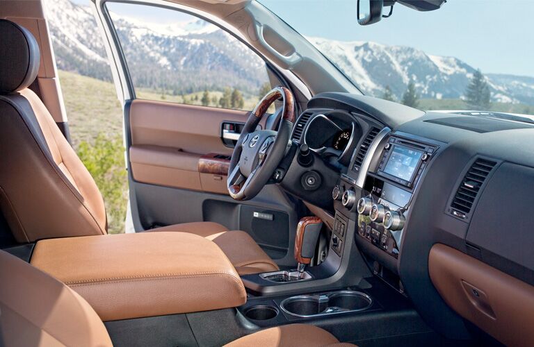 Front two seats and open door inside 2019 Toyota Sequoia